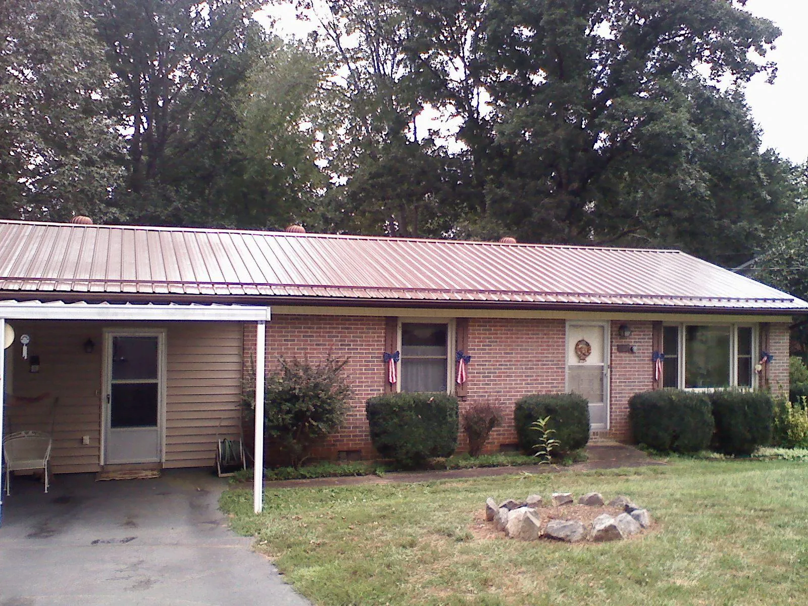 Bronze metal roof and carport on a brick ranch home — Roof Repair work by our crew in Buckingham