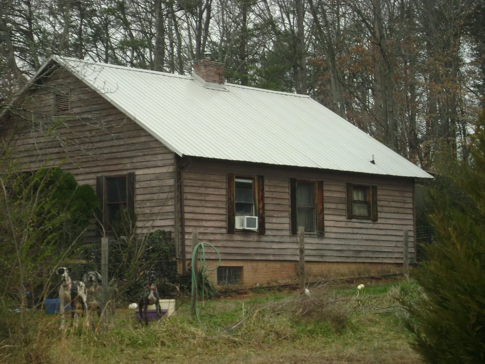 White metal roof on an old wood sided farmhouse, from a Asphalt Shingle Roof Repair job in Buckingham